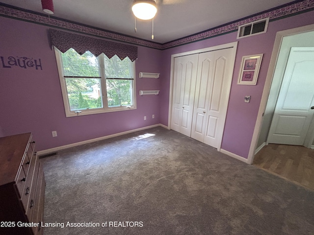 2665 Allium Dr, Holt, MI 48842 - unfurnished bedroom featuring carpet floors, a closet, and a ceiling fan