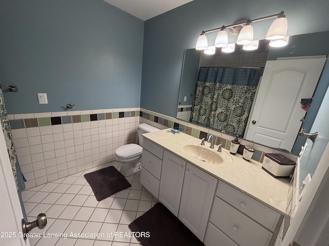 2665 Allium Dr, Holt, MI 48842 - bathroom featuring vanity, tile patterned floors, a wainscoted wall, curtained shower, and tile walls