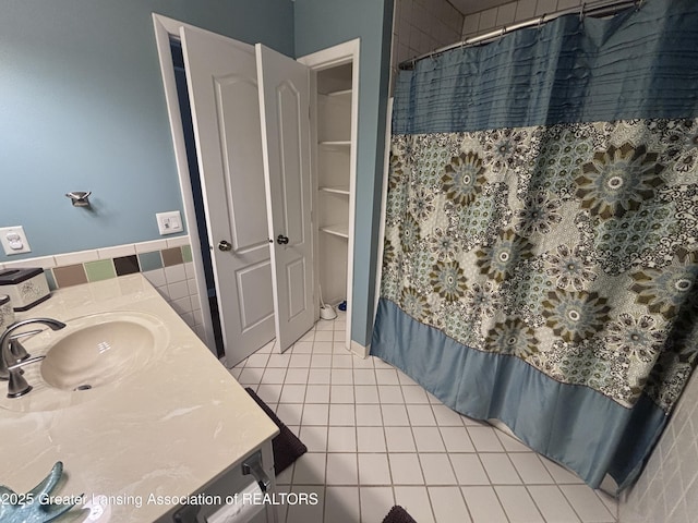 2665 Allium Dr, Holt, MI 48842 - full bath featuring vanity, tile patterned flooring, a shower with shower curtain, tile walls, and a wainscoted wall