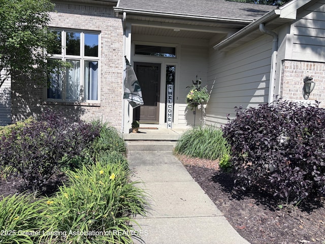 2665 Allium Dr, Holt, MI 48842 - doorway to property with brick siding and roof with shingles