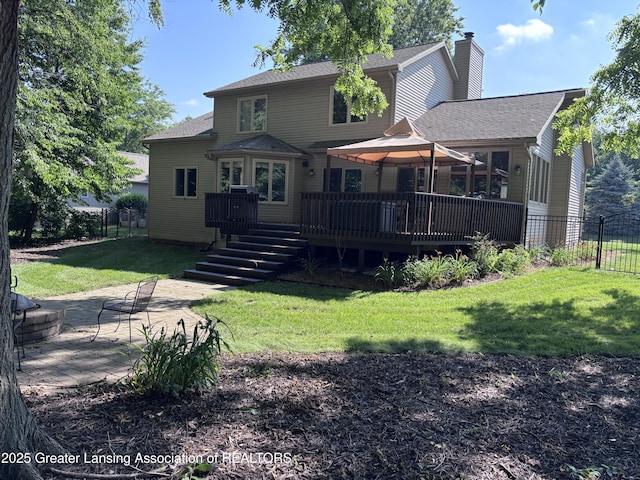 2665 Allium Dr, Holt, MI 48842 - rear view of property with a chimney, a wooden deck, roof with shingles, and a patio area