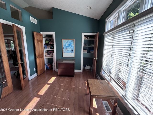 2665 Allium Dr, Holt, MI 48842 - office area with high vaulted ceiling, dark wood finished floors, and french doors
