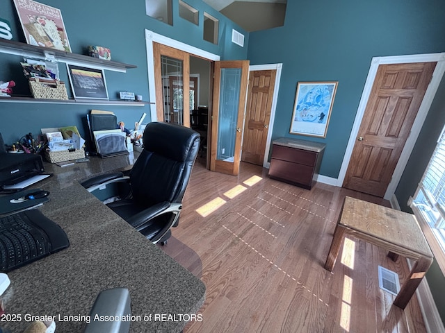 2665 Allium Dr, Holt, MI 48842 - office space with a high ceiling and wood finished floors