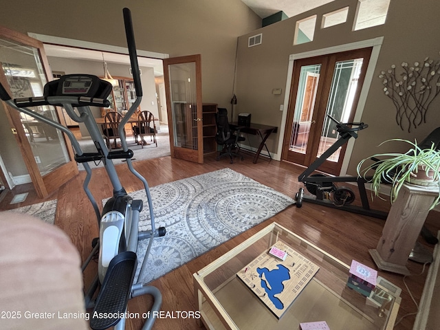 2665 Allium Dr, Holt, MI 48842 - workout area featuring french doors, wood finished floors, healthy amount of natural light, and a high ceiling