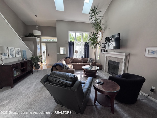 2665 Allium Dr, Holt, MI 48842 - living room with a tiled fireplace, a skylight, and carpet flooring
