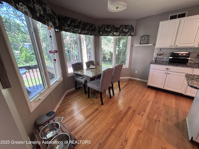 2665 Allium Dr, Holt, MI 48842 - dining area featuring baseboards and light wood finished floors
