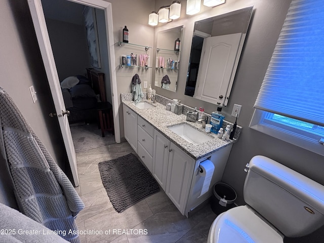 2665 Allium Dr, Holt, MI 48842 - bathroom with marble finish floors, double vanity, and ensuite bath