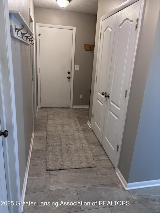 2665 Allium Dr, Holt, MI 48842 - corridor with baseboards and a textured ceiling