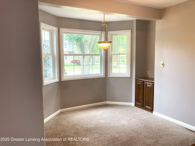 500 Spring St, Grand Ledge, MI 48837 - unfurnished dining area featuring plenty of natural light and carpet floors