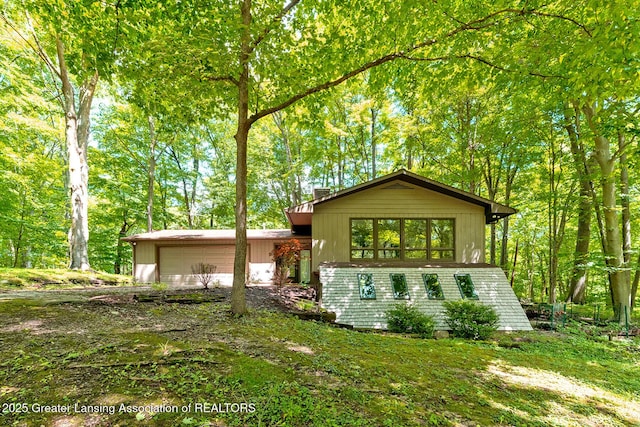 13368 Forest Hill Rd, Grand Ledge, MI 48837 - view of front facade featuring an attached garage and a chimney
