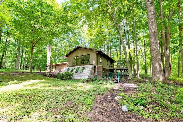 13368 Forest Hill Rd, Grand Ledge, MI 48837 - view of side of home with a deck and brick siding
