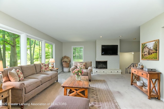 13368 Forest Hill Rd, Grand Ledge, MI 48837 - living room featuring a fireplace and light colored carpet