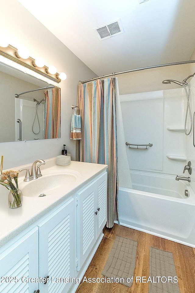 13368 Forest Hill Rd, Grand Ledge, MI 48837 - bathroom with shower / tub combo with curtain, vanity, and wood finished floors