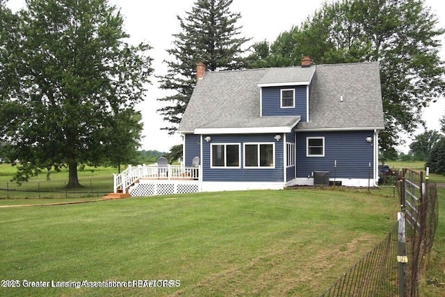 10996 Benton Rd, Grand Ledge, MI 48837 - rear view of property with a deck, a fenced backyard, a chimney, and roof with shingles