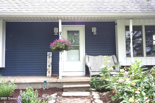 10996 Benton Rd, Grand Ledge, MI 48837 - doorway to property with covered porch and roof with shingles