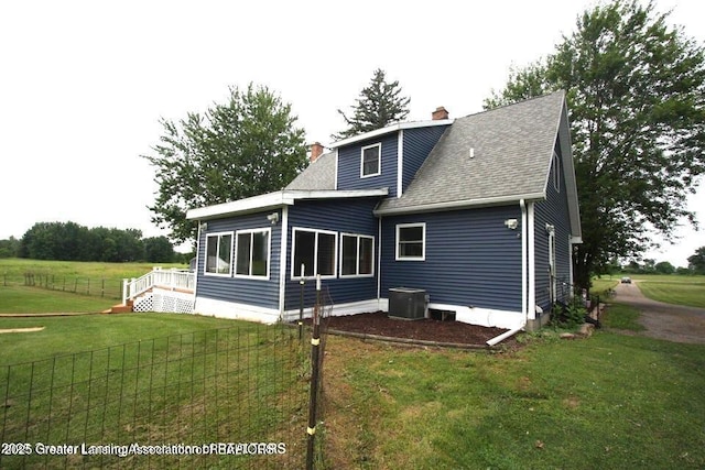10996 Benton Rd, Grand Ledge, MI 48837 - back of house with a chimney and roof with shingles