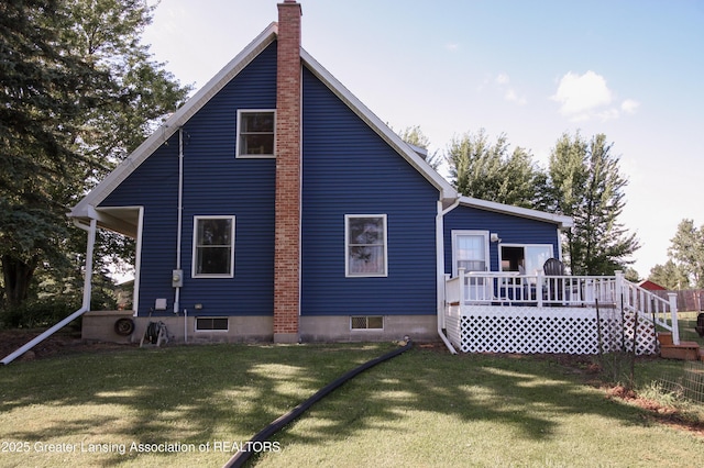 10996 Benton Rd, Grand Ledge, MI 48837 - back of property with a chimney, a yard, and a deck