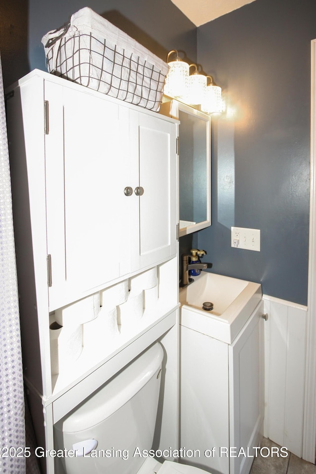 10996 Benton Rd, Grand Ledge, MI 48837 - bathroom with wainscoting and vanity