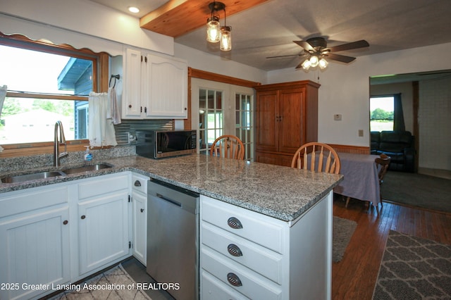 10996 Benton Rd, Grand Ledge, MI 48837 - kitchen with dishwasher, a peninsula, white cabinetry, a ceiling fan, and dark wood-type flooring