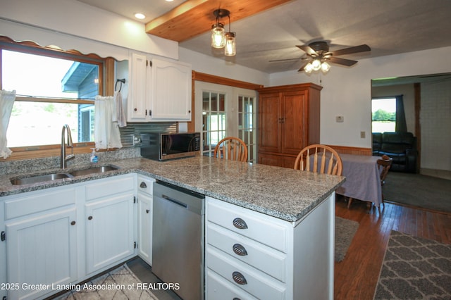10996 Benton Rd, Grand Ledge, MI 48837 - kitchen featuring appliances with stainless steel finishes, a peninsula, white cabinets, light stone counters, and a ceiling fan