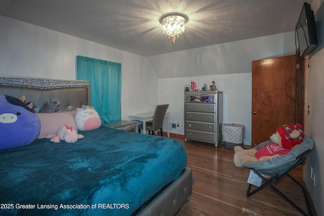 10996 Benton Rd, Grand Ledge, MI 48837 - bedroom with wood-type flooring, a chandelier, and lofted ceiling