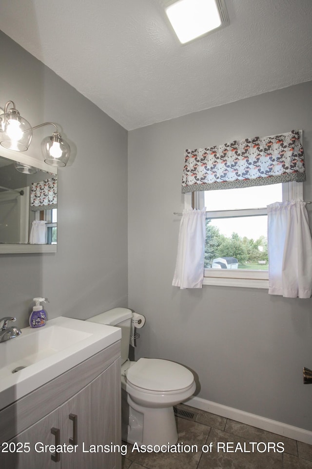 10996 Benton Rd, Grand Ledge, MI 48837 - bathroom featuring vanity, a textured ceiling, and tile patterned flooring