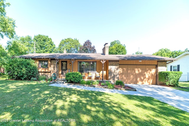 3855 Sandlewood Dr, Okemos, MI 48864 - view of front of house featuring an attached garage, concrete driveway, a chimney, brick siding, and a front yard