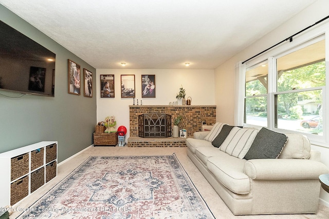 3855 Sandlewood Dr, Okemos, MI 48864 - carpeted living area with a fireplace and baseboards