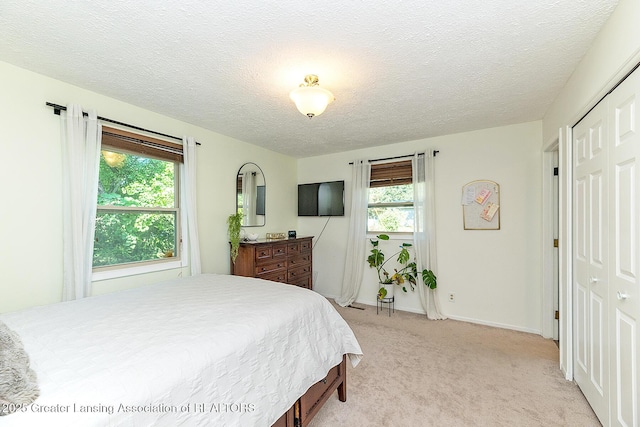 3855 Sandlewood Dr, Okemos, MI 48864 - bedroom with light colored carpet and a textured ceiling
