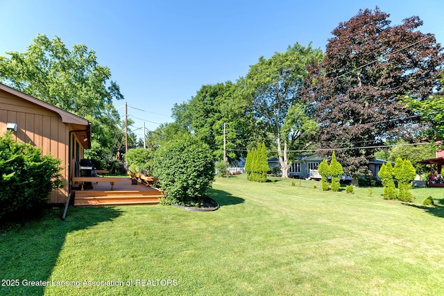 3855 Sandlewood Dr, Okemos, MI 48864 - view of green lawn featuring a wooden deck
