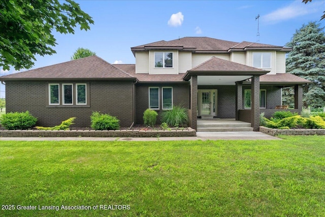 527 Day Rd, Owosso, MI 48867 - view of front of house with brick siding, a front lawn, and a porch