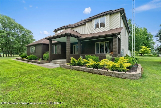 527 Day Rd, Owosso, MI 48867 - view of front of home featuring a front lawn, covered porch, and brick siding