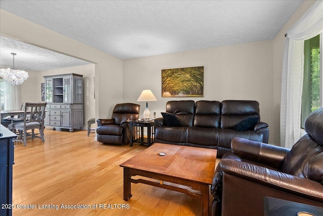 527 Day Rd, Owosso, MI 48867 - living room with light wood finished floors and a chandelier