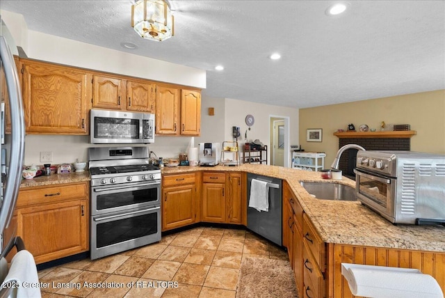 527 Day Rd, Owosso, MI 48867 - kitchen with stainless steel appliances, a peninsula, recessed lighting, a textured ceiling, and light tile patterned flooring
