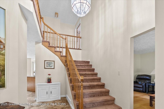 527 Day Rd, Owosso, MI 48867 - stairs featuring a towering ceiling
