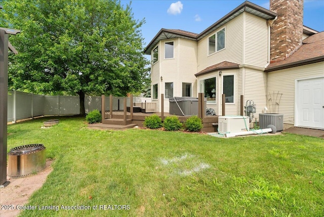 527 Day Rd, Owosso, MI 48867 - rear view of house featuring a deck, a fenced backyard, and a chimney
