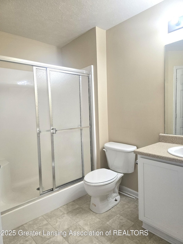 12907 Townsend Dr Unit 612, Grand Ledge, MI 48837 - bathroom featuring vanity, a shower stall, and a textured ceiling