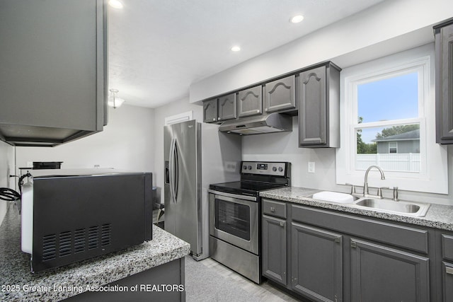9514 Huntington Rd, Battle Creek, MI 49017 - kitchen with under cabinet range hood, stainless steel electric stove, gray cabinets, black microwave, and light countertops