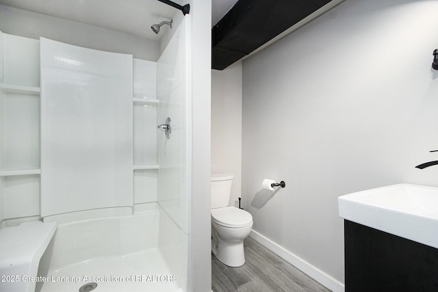 9514 Huntington Rd, Battle Creek, MI 49017 - bathroom featuring wood finished floors, vanity, and a shower