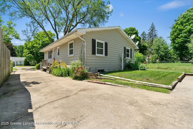 2218 Coolridge Rd, Holt, MI 48842 - view of side of home featuring a lawn and driveway