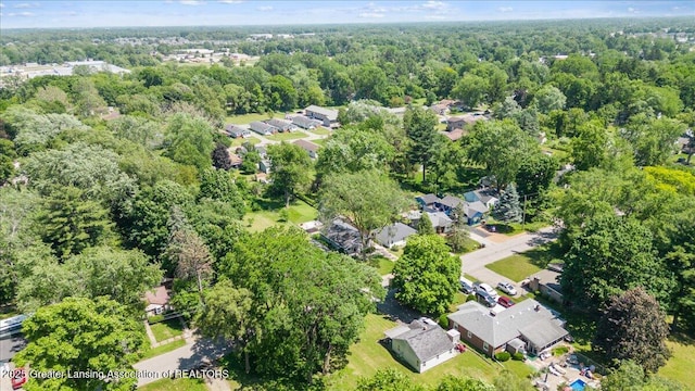 2218 Coolridge Rd, Holt, MI 48842 - aerial view of property and surrounding area with nearby suburban area and a heavily wooded area