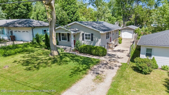 2218 Coolridge Rd, Holt, MI 48842 - view of front of house featuring a front lawn, an outdoor structure, and a detached garage