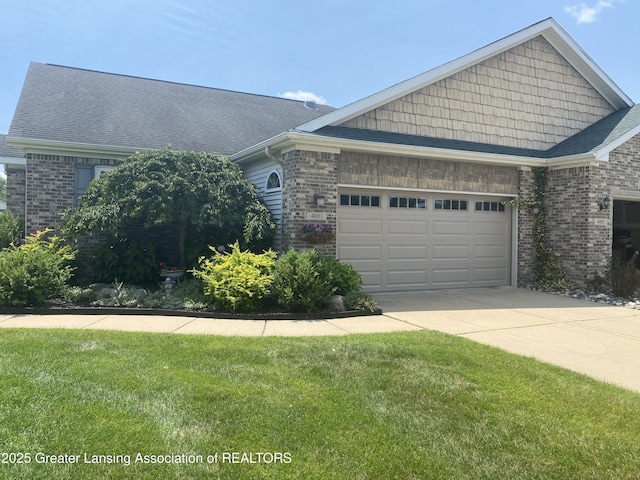 4001 Canyon Cv # 56, Holt, MI 48842 - view of front of house with concrete driveway, a garage, brick siding, and a front yard