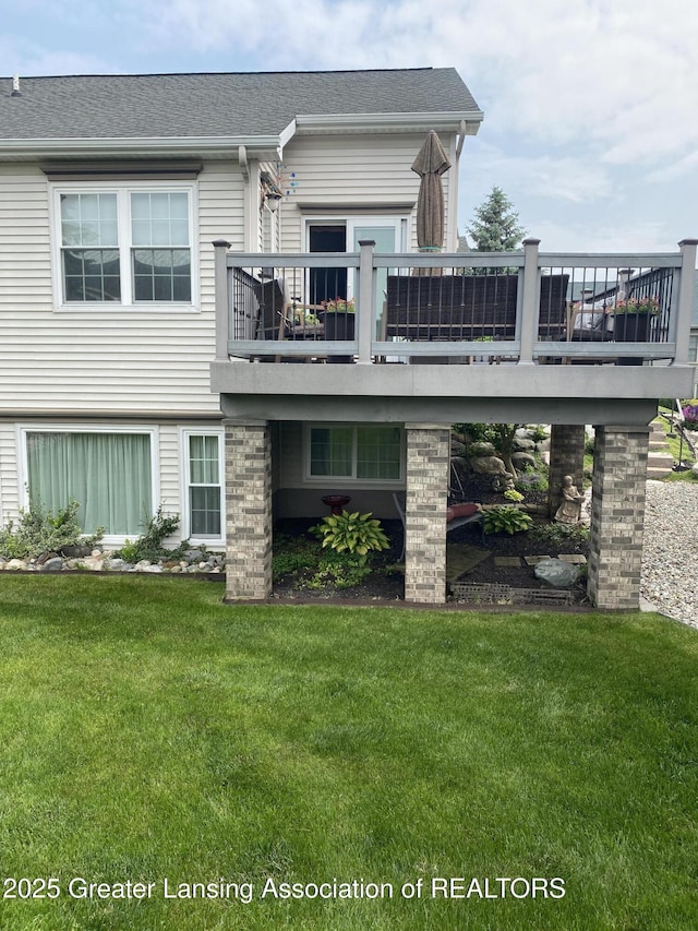 4001 Canyon Cv # 56, Holt, MI 48842 - back of house with a wooden deck and a yard