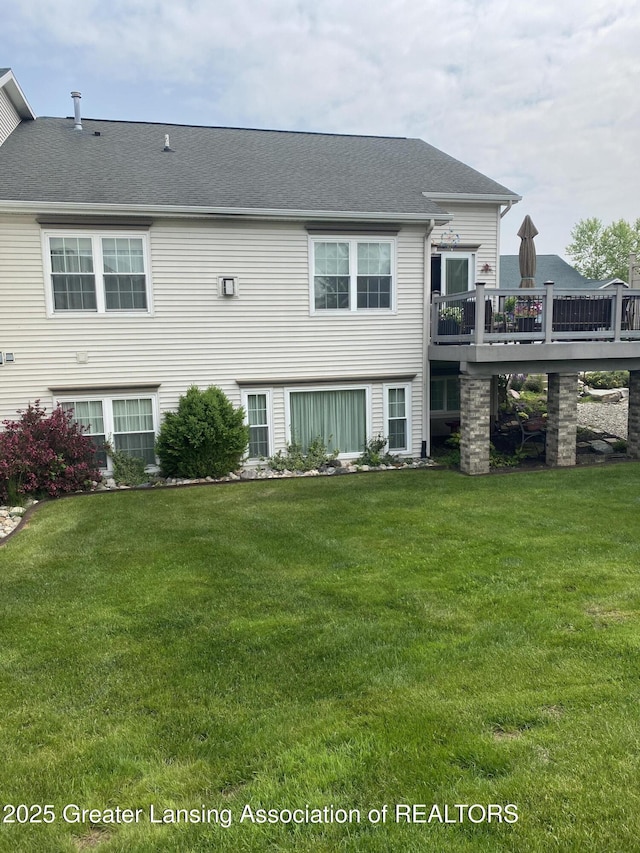 4001 Canyon Cv # 56, Holt, MI 48842 - rear view of house featuring a wooden deck, a yard, and a shingled roof