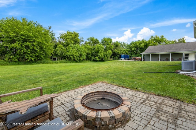 14747 Forest Hill Rd, Grand Ledge, MI 48837 - view of green lawn with an outdoor fire pit and a patio area