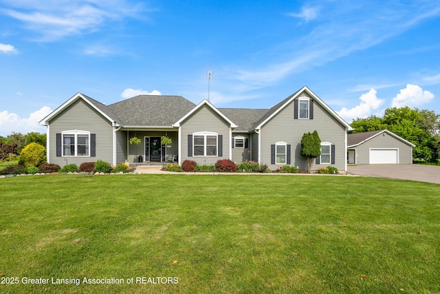 14747 Forest Hill Rd, Grand Ledge, MI 48837 - view of front facade with a front lawn, a detached garage, an outbuilding, and roof with shingles