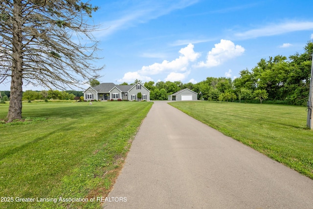 14747 Forest Hill Rd, Grand Ledge, MI 48837 - ranch-style home featuring an outbuilding, a detached garage, and a front lawn