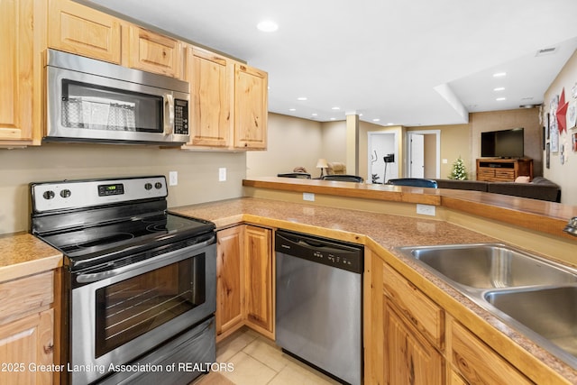 14747 Forest Hill Rd, Grand Ledge, MI 48837 - kitchen featuring appliances with stainless steel finishes, light brown cabinets, light tile patterned flooring, open floor plan, and recessed lighting
