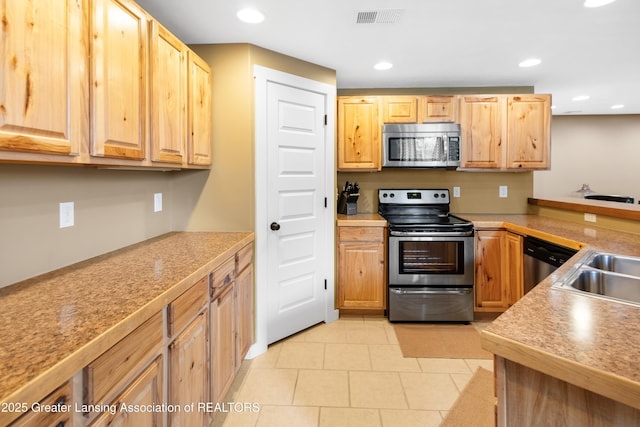 14747 Forest Hill Rd, Grand Ledge, MI 48837 - kitchen featuring appliances with stainless steel finishes, light brown cabinets, light tile patterned floors, light countertops, and recessed lighting